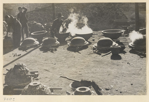 Workers and molds for iron cooking pots at a foundry near Mentougou Qu