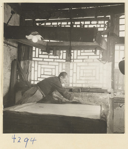 Man cutting tofu in a tofu-making shop