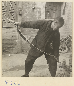 Man making a bow in a bow-and-arrow-making shop