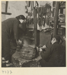Woman and man at work in a metal-working shop