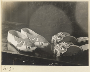 Children's shoes apliquéd with fish and tiger motifs