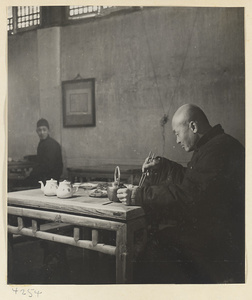 Restaurant interior showing a man eating at a table