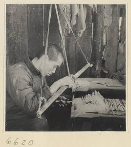 Man finishing a comb in a horn-comb workshop