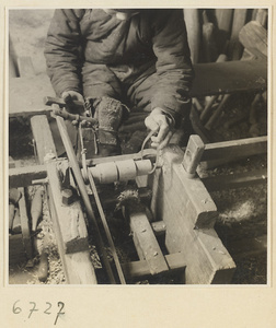 Carpenter using calipers to measure a piece of turned wood at a lathe