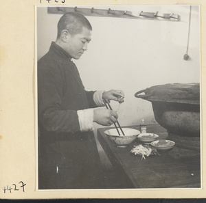 Kitchen of Niu Rou Wan, a Muslim grilled-beef restaurant, showing a chef mixing marinade