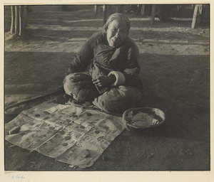 Fortune teller with cane, sign, coins, and basket
