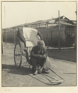 Rickshaw-puller sitting on his rickshaw