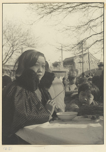 Woman and child eating at a food stand