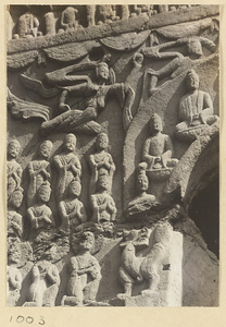 Detail of Cave 44 at Yun'gang showing the north wall with Buddhist relief figures including Buddhas, flying Apsaras, and donors