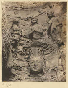Detail of Cave 18 at Yun'gang showing the east wall with the head of an attendant Bodhisattva and other relief figures