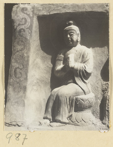 Interior detail of a cave temple at Yun'gang showing a niche with a seated Buddha