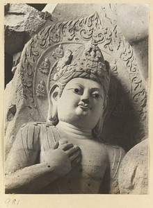 Detail showing the head and arm of a statue of a Bodhisattva at the Yun'gang Caves