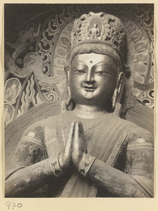Detail showing the head and hands of a statue of a Bodhisattva at the Yun'gang Caves