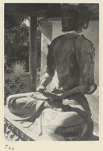 Statue of a Bodhisattva in a small brick pavilion at Qufu