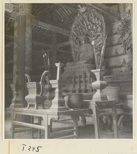 Interior of a temple building at Ling yan si showing an altar with a statue of Buddha