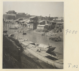 Boats on the river at Tai'an with houses and city walls in the background