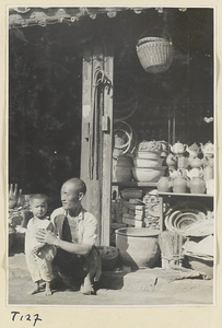 Man and child in front of shop selling household goods in Tai'an