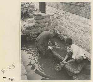 Village men washing vegetables in the river at Ji'nan