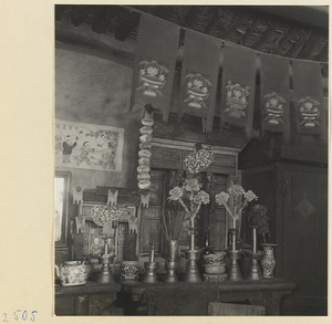 Building interior showing an altar with ritual objects and decorative objects in a village on the Shandong coast