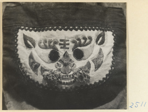 Embroidered purse from a village on the Shandong coast with design showing an animal face