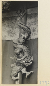 Carved dragon entwined around a pole in a village on the Shandong coast