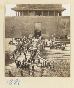 Funeral procession passing through a city gate