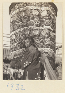 Member of a funeral procession carrying an embroidered umbrella