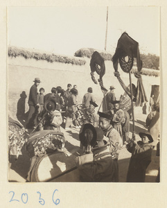 Members of a wedding procession standing with draped mirrors and musical instruments