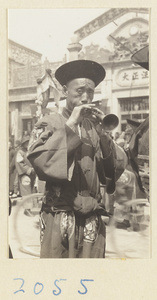 Musician playing a suo na in a wedding procession