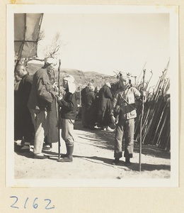 Pilgrims buying peach-wood walking sticks on Miaofeng Mountain