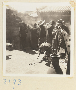 Pilgrims burning incense in a brick incense burner on Miaofeng Mountain