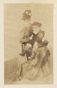 Anna Drew sitting with her child