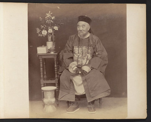 Unidentified Chinese government official wearing traditional hat and surcoat with Mandarin square