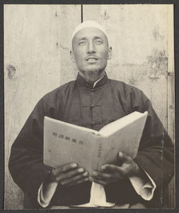 [China.  Muslim man reading from a book.]