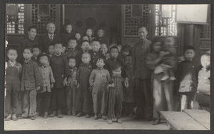 Missionary with Chinese men and school children