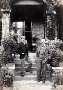 Herbert Wilcockson and Ernest George Hayward on steps by a house