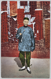 A Chinese man, with a pipe and wall posters, San Francisco