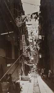 A pawnbroker, and laundry drying above a narrow street, Hong Kong