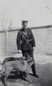 John Montgomery wearing Shanghai Municipal Police uniform, with two dogs