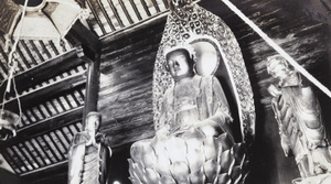 Temple sculpture of Buddha seated on a lotus flower