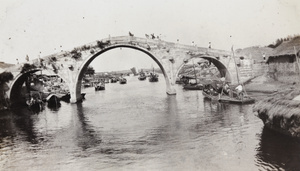 Three arched stone bridge photographed from a boat