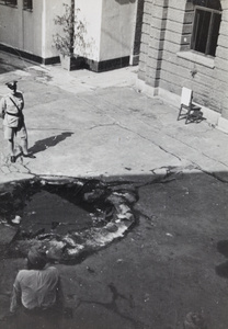 A shell crater in the compound of the Wayside Police Station, Shanghai, 1937