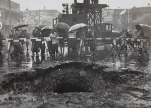 Onlookers at crater, Avenue Edward VII and Yu Ya Ching Road, Shanghai, caused by bomb dropped on 14 August 1937