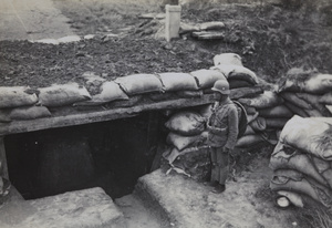 Nationalist soldier at dugout near Hungjao, Shanghai, 1937