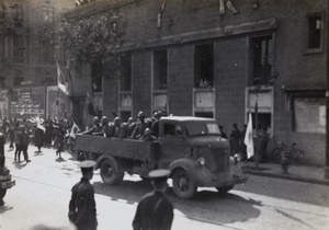 Japanese marines and truck taking part in victory parade through International Settlement, Shanghai, 1937