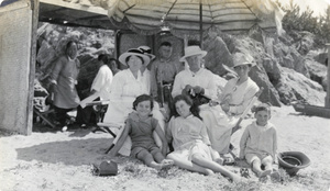 Family group with Chinese servants at a beach