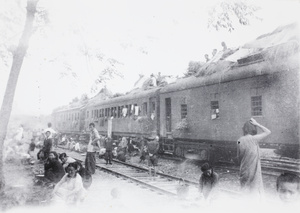 Train carriages with thatched shelters, during retreat from Guilin, 1944