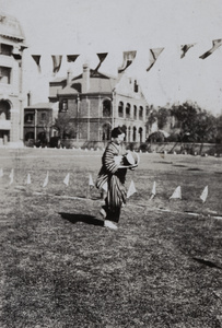 A woman holding a ball during a sports event at the grounds of Mitsui & Co., Ltd. (三井物産) company buildings, Shanghai (上海)