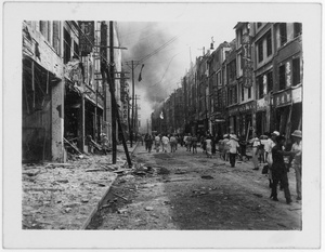Bomb damaged shops and a burning building, Chongqing