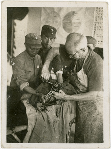 Dr Norman Bethune (白求恩) operating on an injured soldier in the Songyan Kou model ward, Wutai